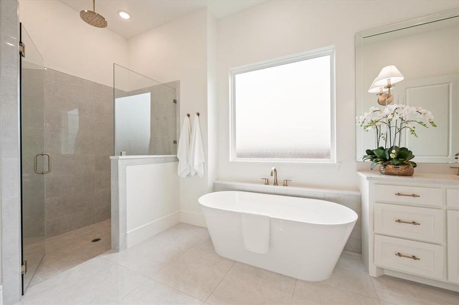 Bathroom featuring independent shower and bath, tile patterned floors, and vanity