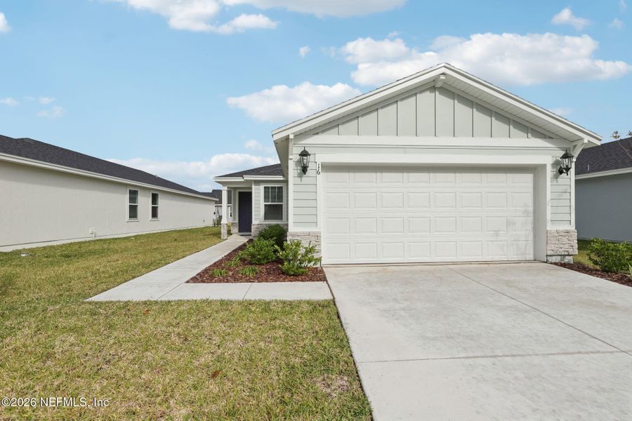 Front exterior of a new home in Flagler Village - Classic Series, Palm Coast, FL, highlighting curb appeal (Image 18).