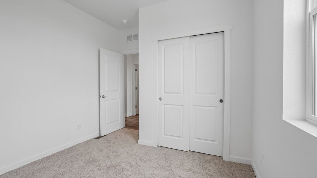 Secondary bedroom with closet, window, and modern finishes. Secondary bedroom with closet, window, and modern finishes.