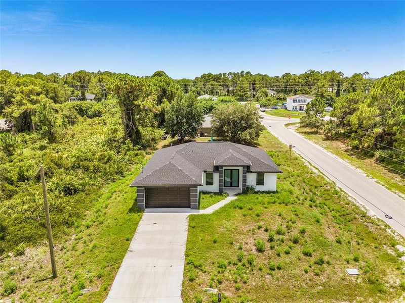 Front exterior of a new home in , Lehigh Acres, FL, highlighting curb appeal (Image 14).
