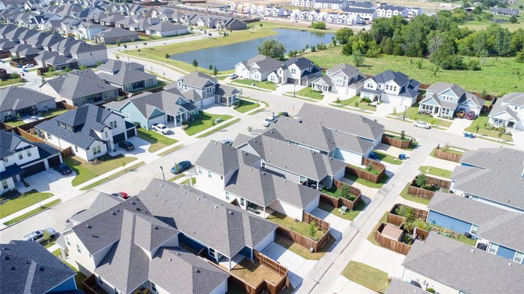 Aerial perspective of suburban area featuring a large body of water