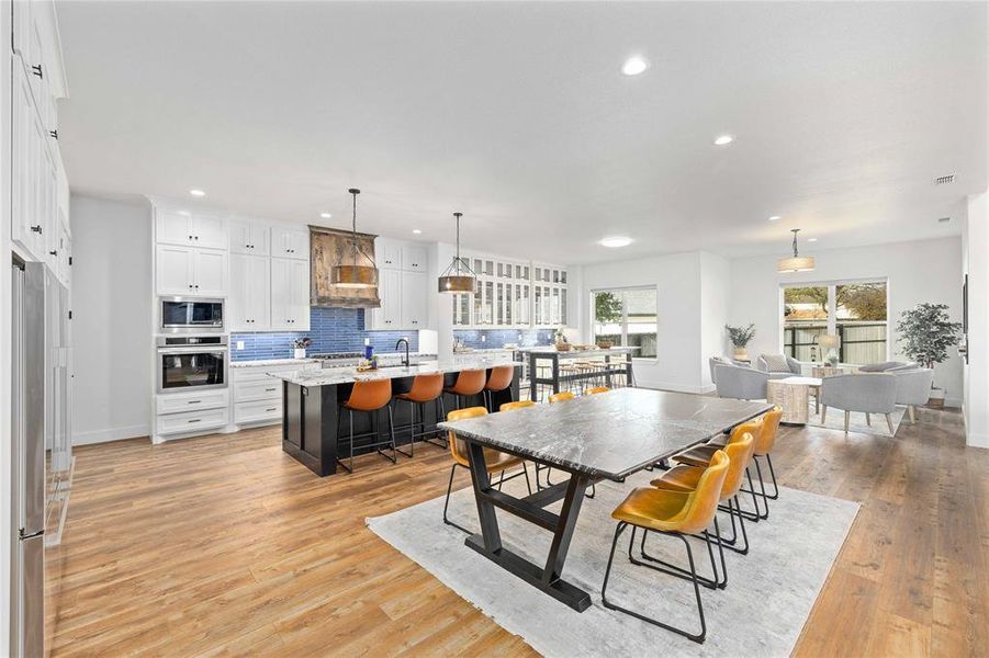 Dining room featuring light wood-type flooring and recessed lighting
