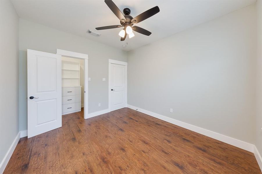 Second bedroom featuring a spacious walk-in closet, offering ample storage and a comfortable, organized living space.