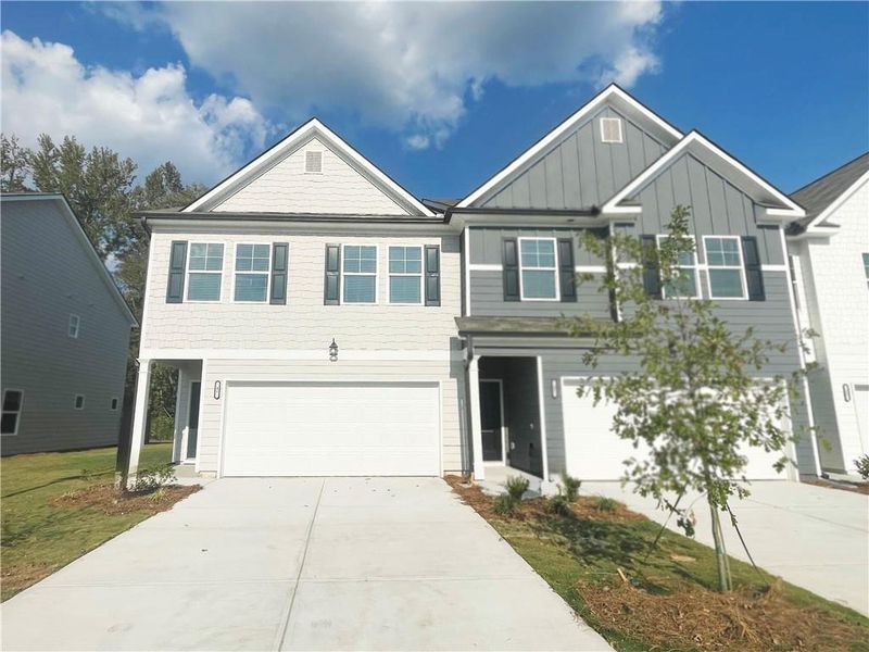 Front exterior of a new home in , Hoschton, GA, highlighting curb appeal (Image 1).
