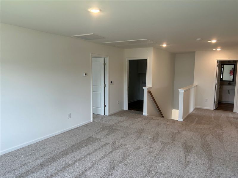 A versatile loft area features soft carpeting and