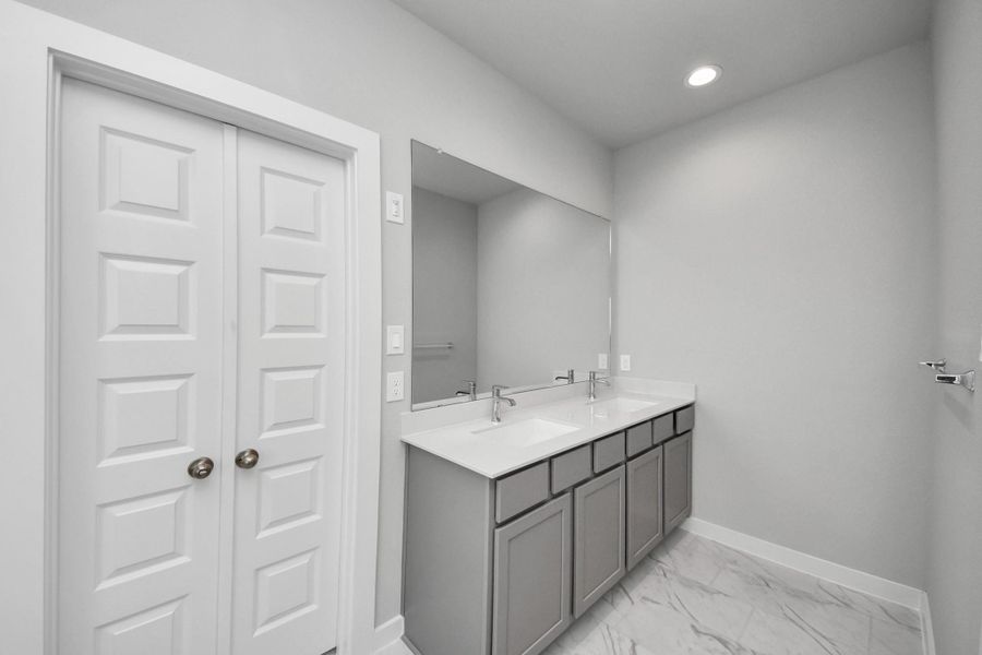 Elevate your daily routine at the elegant vanity, now equipped with double sinks, light countertops, modern hardware, and beautiful recessed lights. Elevate your daily routine at the elegant vanity, now equipped with double sinks, light countertops, modern hardware, and beautiful recessed lights.