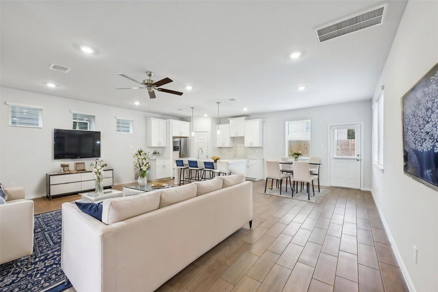 Gorgeous wood-inspired tiles across the central living spaces bring warmth and a welcoming vibe.