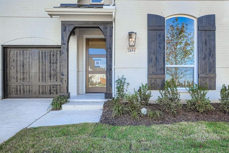 View of exterior entry featuring brick siding