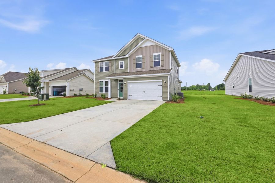 Front exterior of a new home in Edgefield, Loris, SC, highlighting curb appeal (Image 2). Front exterior of a new home in Edgefield, Loris, SC, highlighting curb appeal (Image 2).