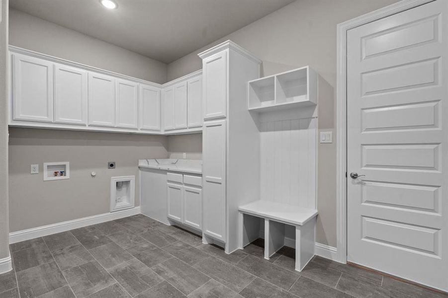 Laundry room with hookup for a gas dryer, hookup for a washing machine, cabinets, and electric dryer hookup. Not actual home. Previous built example.