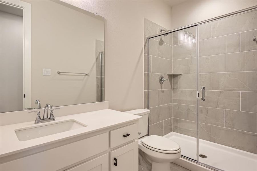 Full bath featuring a stall shower and vanity Full bath featuring a stall shower and vanity