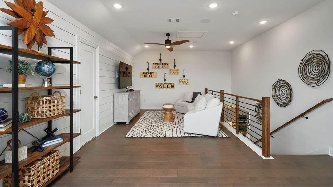 Living area with recessed lighting, ceiling fan, dark wood finished floors, and an upstairs landing Living area with recessed lighting, ceiling fan, dark wood finished floors, and an upstairs landing