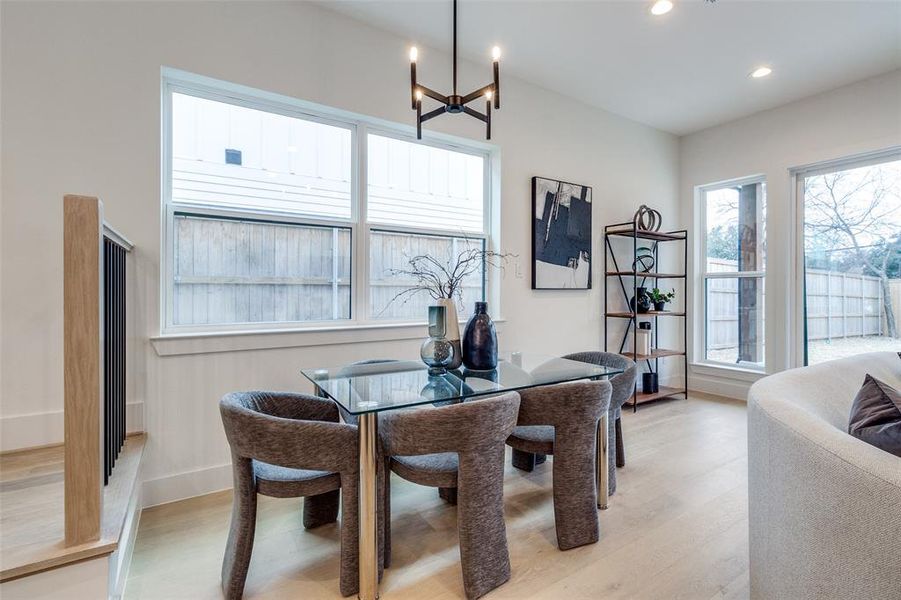 Dining room featuring an inviting chandelier and light hardwood / wood-style flooring