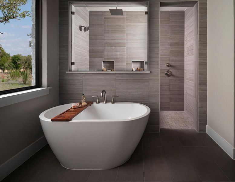 Full bathroom with a freestanding tub, walk in shower, tile walls, and tile patterned flooring