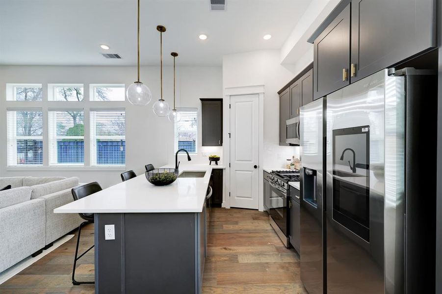 Modern Chef's Kitchen: Sleek cabinetry, high-end appliances, and an expansive island set a stage for culinary excellence and entertaining ease.