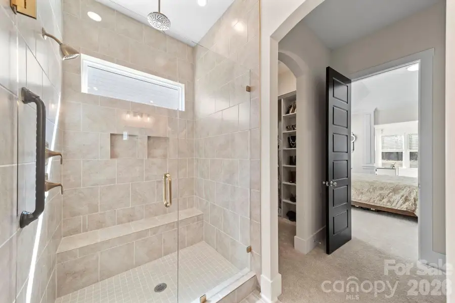 Primary Tiled Shower with Rain Head Faucet and Transom Window for extra light