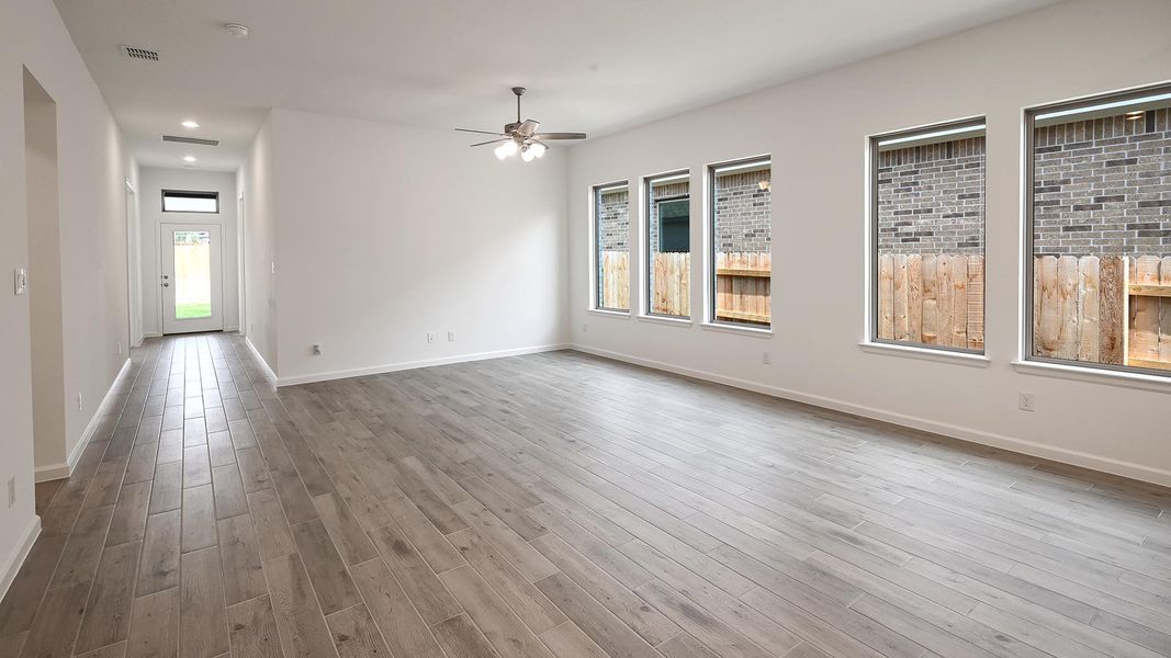 Spare room featuring ceiling fan, light wood-style floors, and recessed lighting Spare room featuring ceiling fan, light wood-style floors, and recessed lighting
