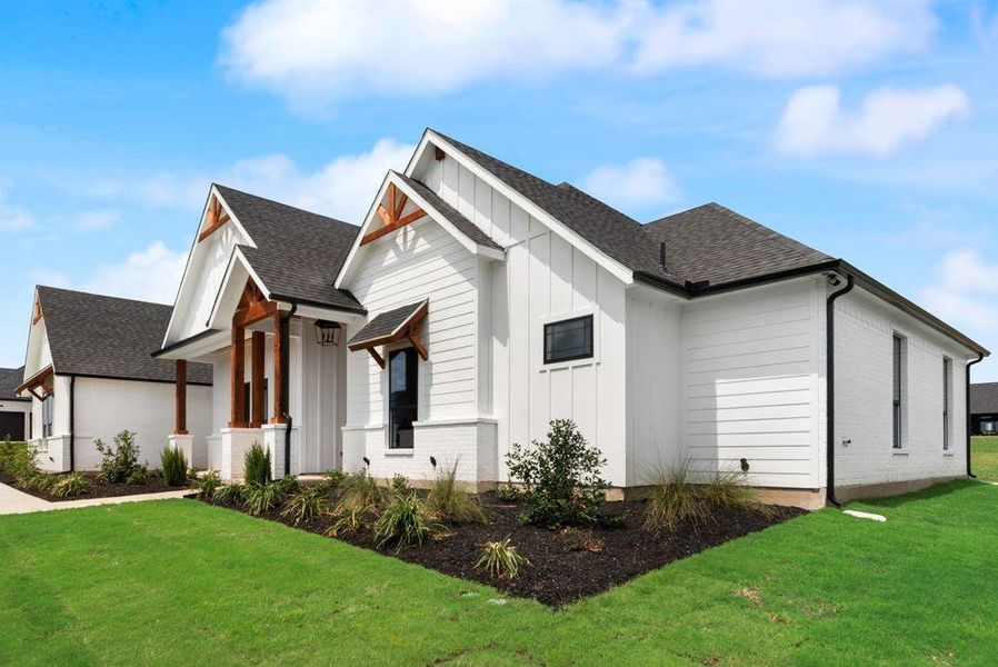 View of property exterior with board and batten siding, a lawn, and roof with shingles View of property exterior with board and batten siding, a lawn, and roof with shingles