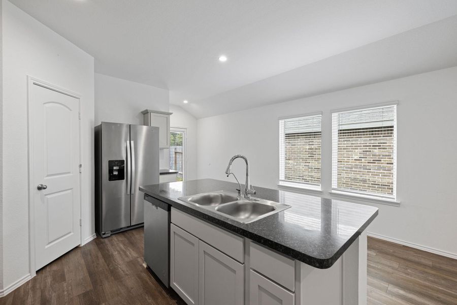 The island provides additional counter space and the fridge stays. The island provides additional counter space and the fridge stays.