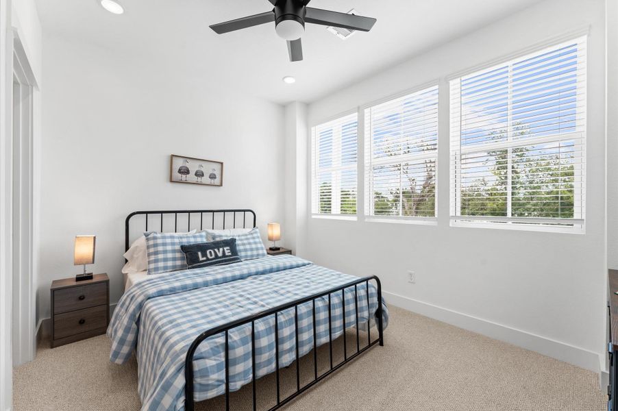 This cozy secondary bedroom offers a peaceful retreat with soft natural light and a versatile layout perfect for guests, a home office, or a growing family. Neutral tones and plush carpeting create a warm, welcoming atmosphere, while a spacious closet and thoughtful lighting add comfort and functionality. Whether styled for rest or productivity, this room adapts beautifully to your needs. Ceiling fans are not included.