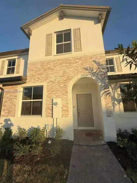 Front exterior of a new home in , Homestead, FL, highlighting curb appeal (Image 1). Front exterior of a new home in , Homestead, FL, highlighting curb appeal (Image 1).