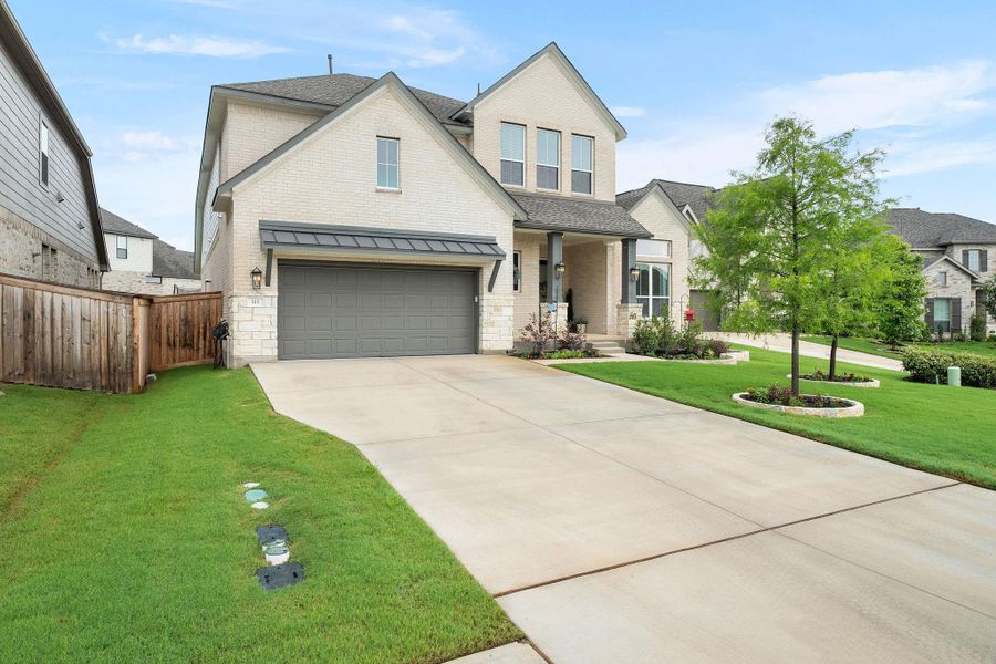 A cream brick facade and covered entryway invite you to this home featuring a two-car garage.