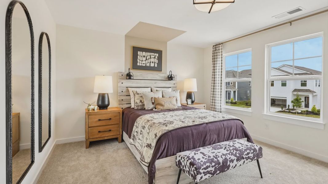 Secondary bedroom with carpet, closet, and window