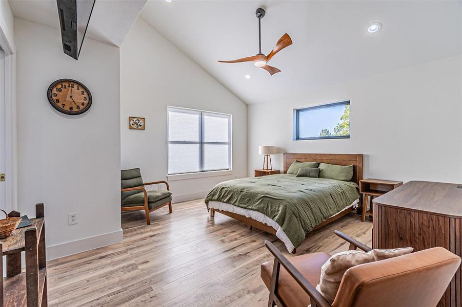Bedroom featuring lofted ceiling, light wood finished floors, a ceiling fan, and recessed lighting