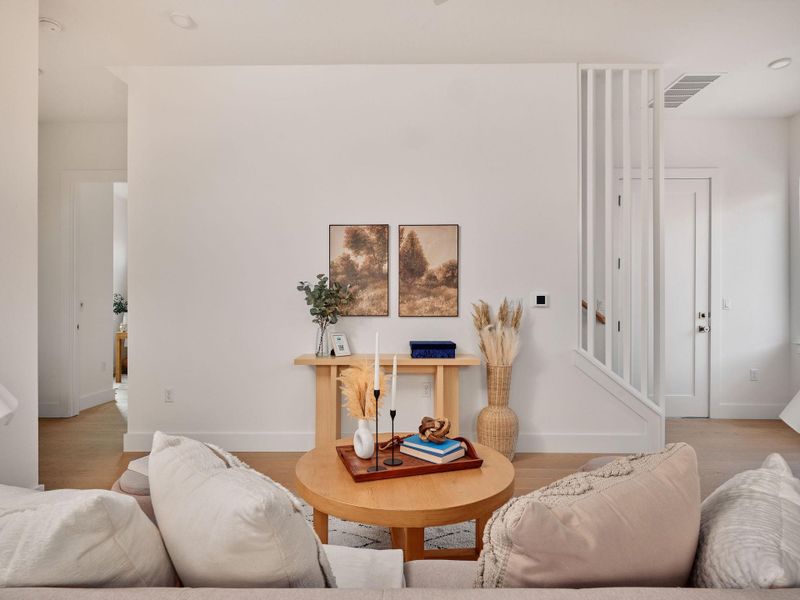 Living area with wood finished floors and baseboards