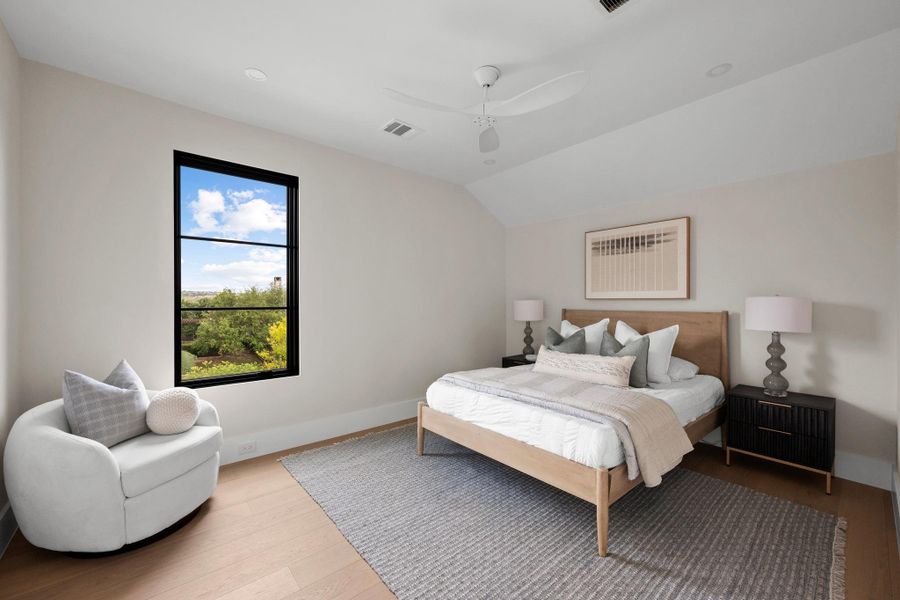 The self-contained guest residence includes this private, view-filled bedroom suite, complete with a full bath and sweeping vistas