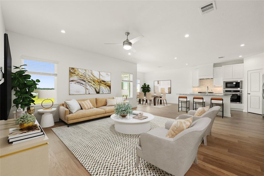 This expansive family room flows effortlessly into a stunning, state-of-the-art kitchen, ideal for hosting gatherings. Enjoy a bright environment with ample recessed lighting, beautiful light wood flooring, and a sleek modern aesthetic. *Virtually Staged