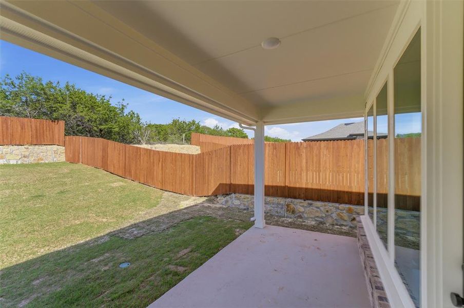 Fenced backyard with a patio area