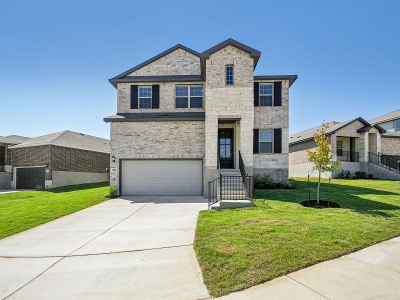 Front exterior of a new home in Comanche Ridge, San Antonio, TX, highlighting curb appeal (Image 1).