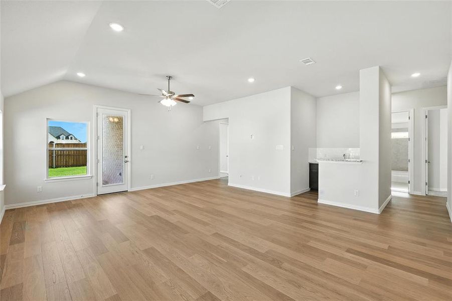 Unfurnished living room featuring recessed lighting, ceiling fan, and light wood-style flooring