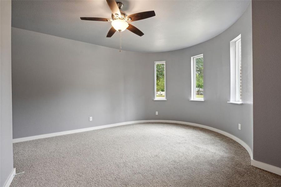 Carpeted spare room with ceiling fan