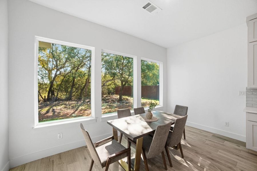 Dining area featuring light wood-style floors and baseboards Dining area featuring light wood-style floors and baseboards