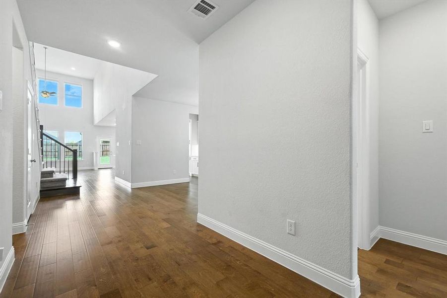 Entry into home, showcasing the expansive ceilings, and wide halls!