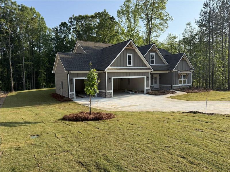 Front exterior of a new home in Woodland Hills, Loganville, GA, highlighting curb appeal (Image 2). Front exterior of a new home in Woodland Hills, Loganville, GA, highlighting curb appeal (Image 2).