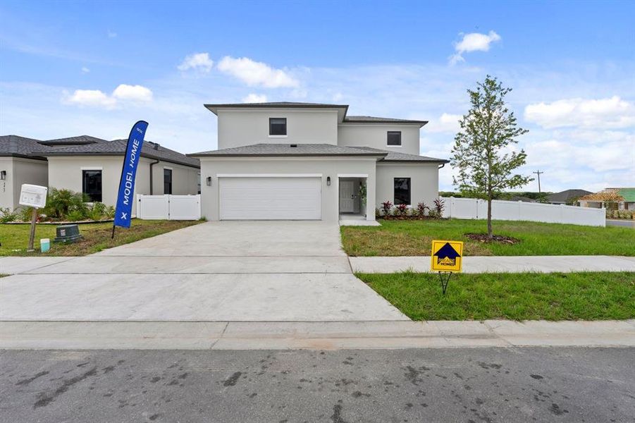 Front exterior of a new home in On Villa Pass, Mascotte, FL, highlighting curb appeal (Image 1). Front exterior of a new home in On Villa Pass, Mascotte, FL, highlighting curb appeal (Image 1).