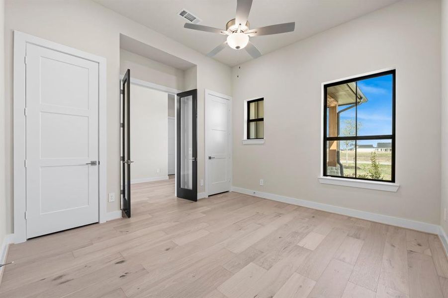 The Study/Home Office with Double Glass Doors, 2 Storage Closets, and Fan.