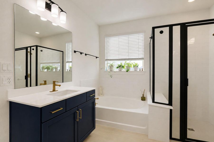 A well-appointed bathroom featuring a contemporary vanity, a deep soaking tub, and a sleek glass-enclosed shower. A well-appointed bathroom featuring a contemporary vanity, a deep soaking tub, and a sleek glass-enclosed shower.