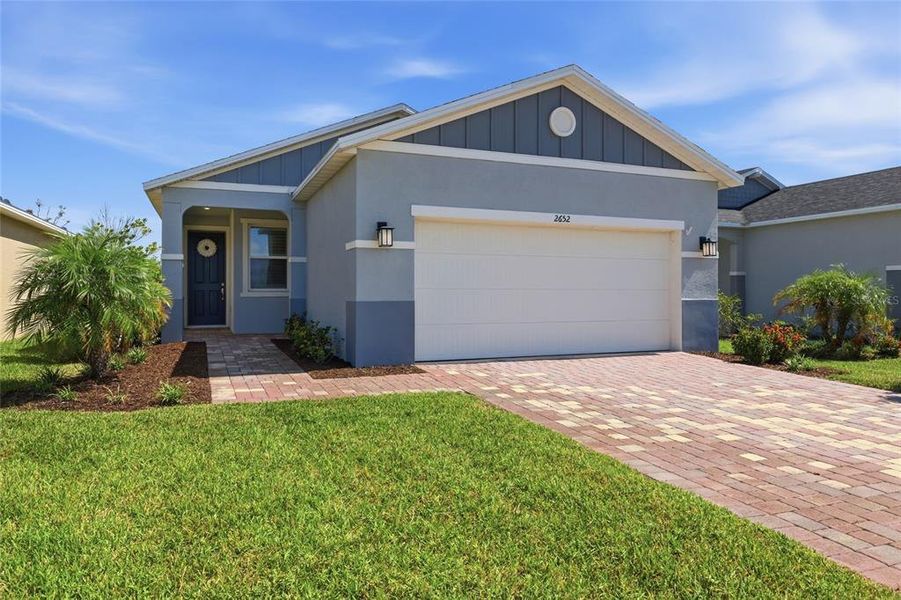 Front exterior of a new home in Heron Bay, Palmetto, FL, highlighting curb appeal (Image 24). Front exterior of a new home in Heron Bay, Palmetto, FL, highlighting curb appeal (Image 24).