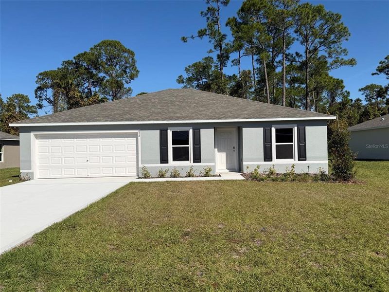 Front exterior of a new home in Poinciana, Poinciana, FL, highlighting curb appeal (Image 1).