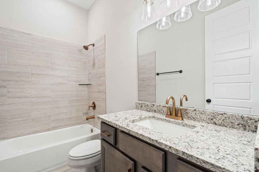 Full bath featuring vanity and bathing tub / shower combination