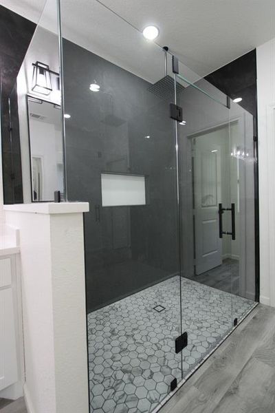Full bathroom featuring a stall shower, wood finished floors, and vanity Full bathroom featuring a stall shower, wood finished floors, and vanity