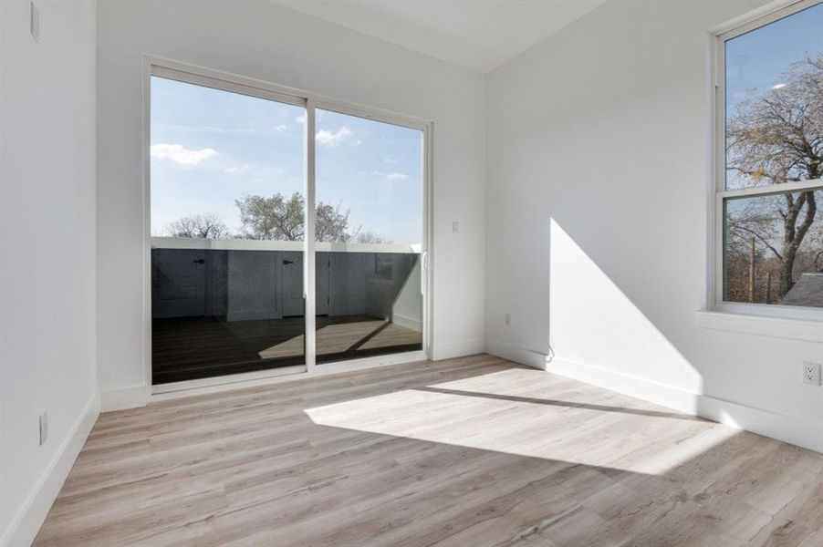 Unfurnished room featuring light wood-style flooring and baseboards