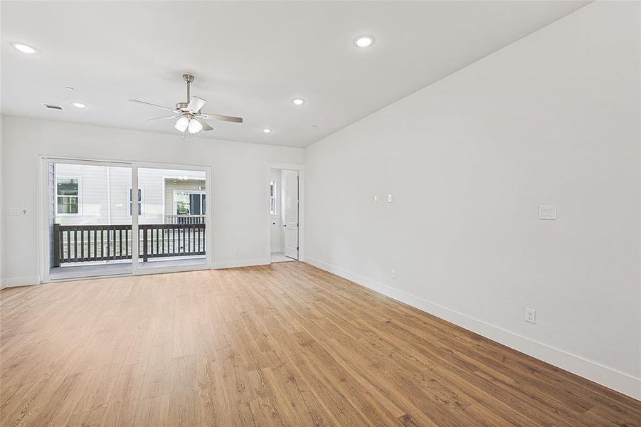 Spare room with light wood-style flooring, a ceiling fan, and recessed lighting