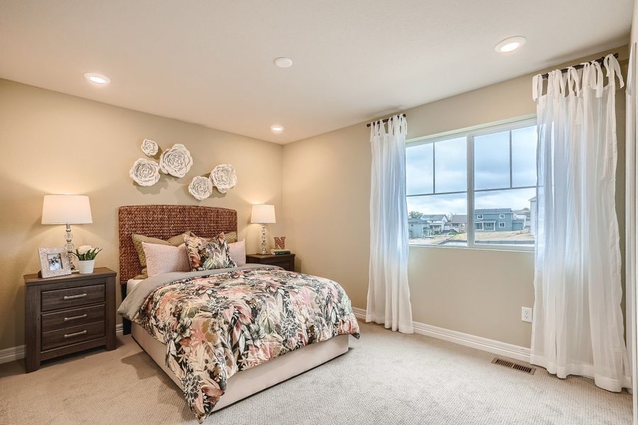 A bedroom with a large window.