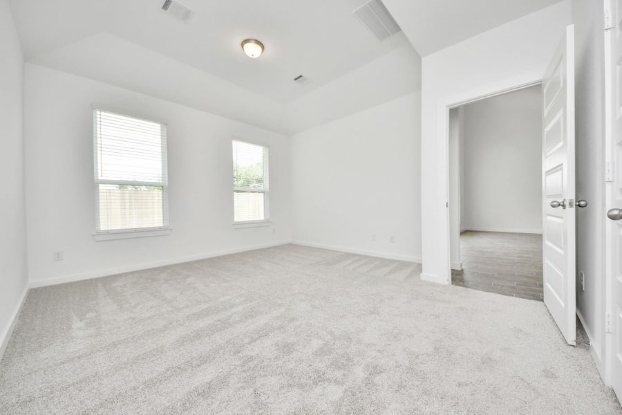 Come and unwind after a long day in this magnificent primary suite! This spacious room features plush carpet, warm paint, high ceilings and large windows with privacy blinds. Come and unwind after a long day in this magnificent primary suite! This spacious room features plush carpet, warm paint, high ceilings and large windows with privacy blinds.