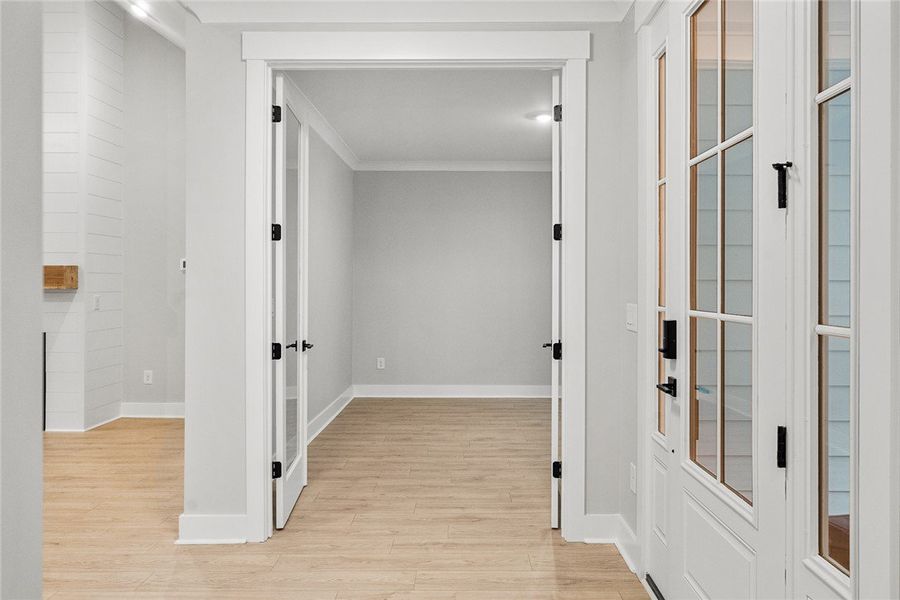 A graceful entry with glass-paneled doors invites A graceful entry with glass-paneled doors invites